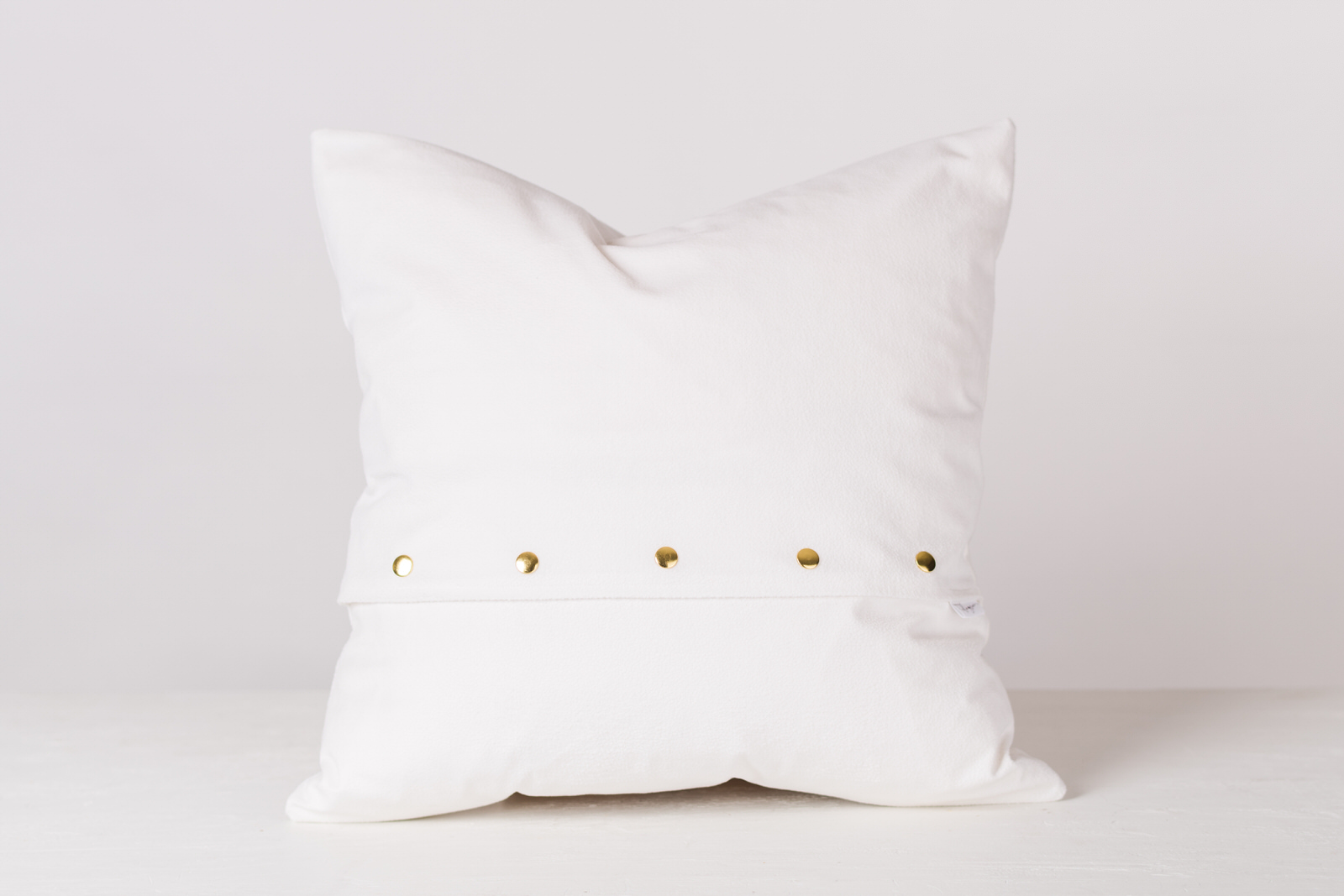 white and pink velvet throw pillow