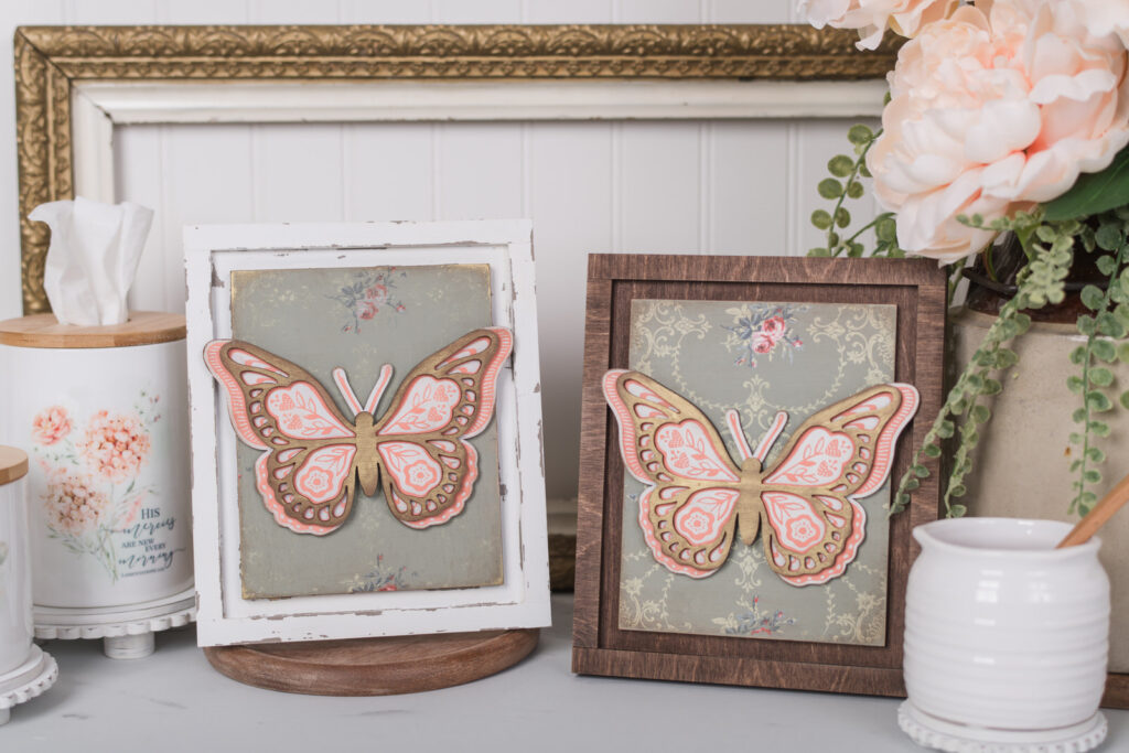 Finished DIY home decor pieces showcasing a butterfly design using chalk couture transfer on an IOD paint inlay wood background insert inside an interchangeable frame.