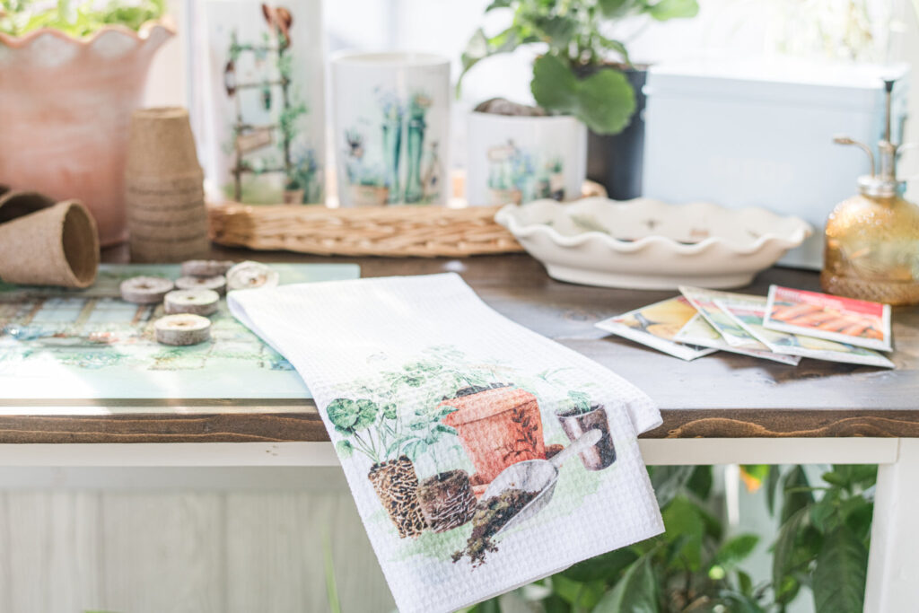 Potting table in sunroom with country garden, tea towel and canisters 