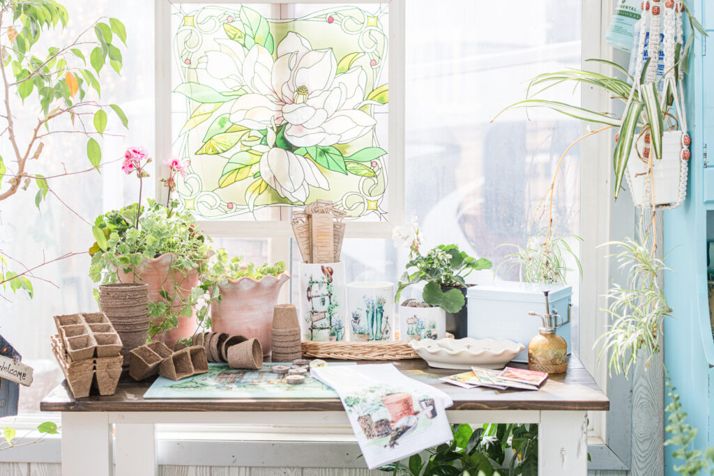 Potting table in sunroom with country garden, tea towel and canisters 