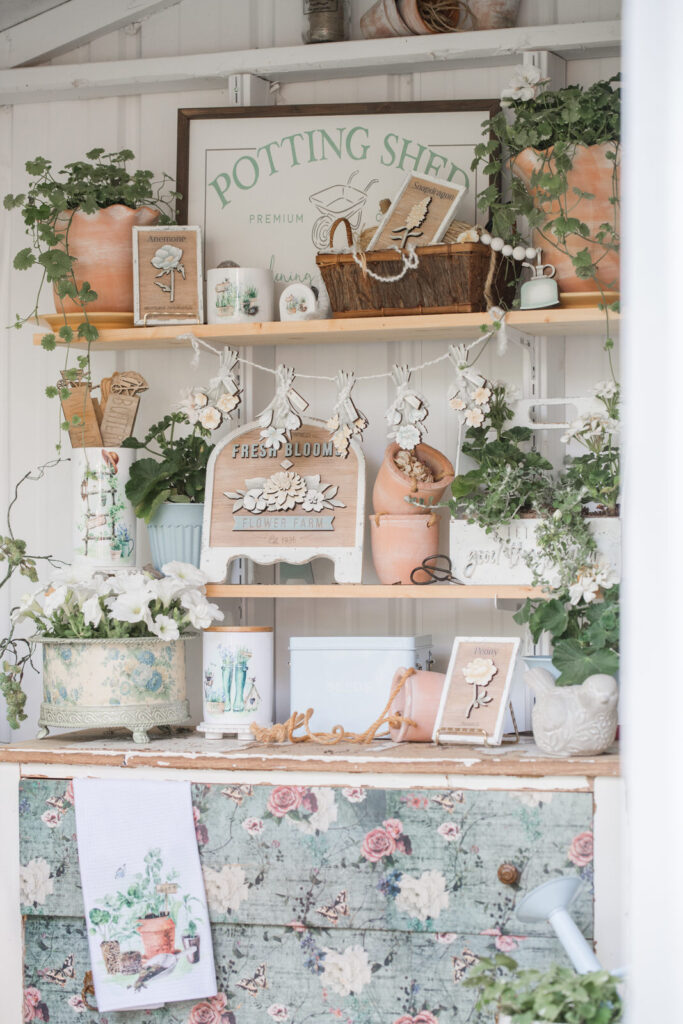 Styled pretty decor on shelving in a garden shed or she shed