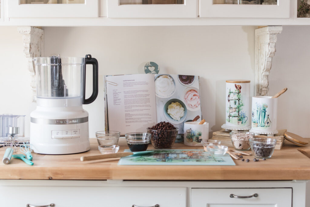 Kitchen Aid, food processor with garden-themed kitchen, essentials for food, prepping, and baking. Glass cutting board for prep and canisters for storage. 