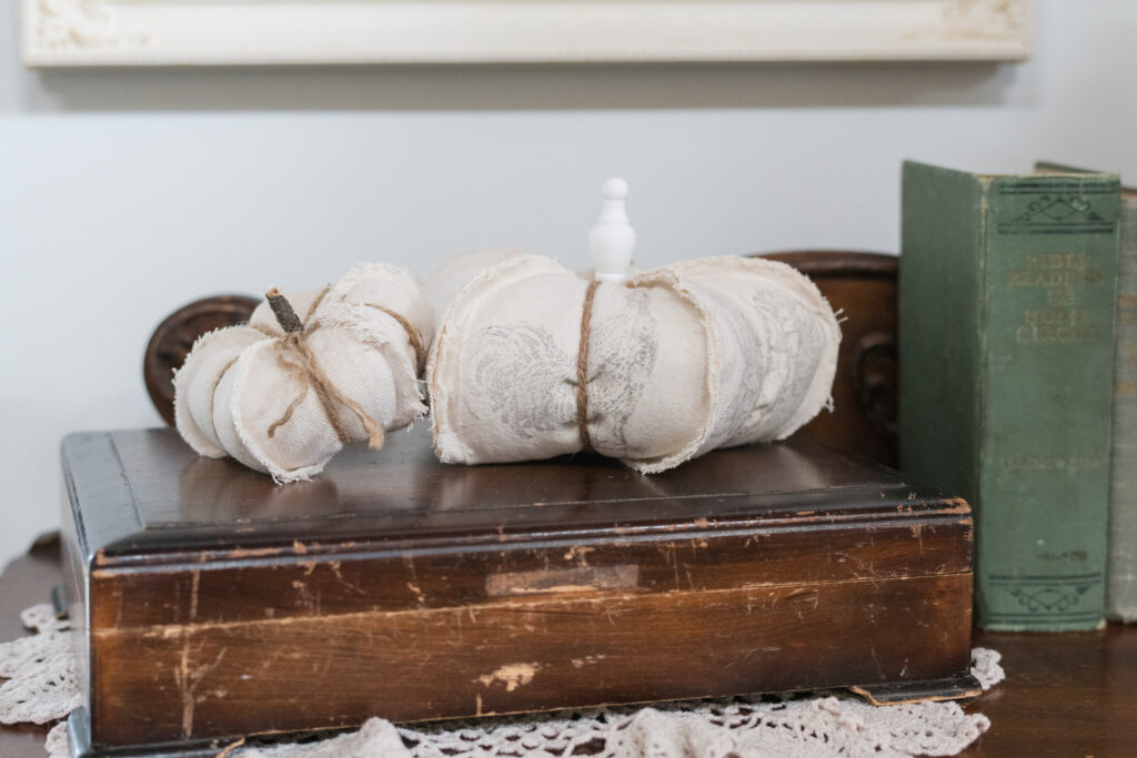 Drop cloth DIY pumpkins, nestled on top of silverware chest
