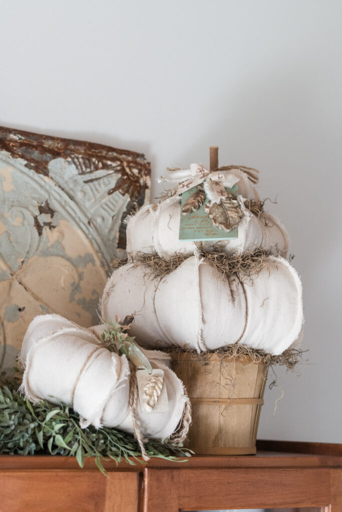 DIY fall acorn and leave tags on a small topiary pumpkin in kitchen 