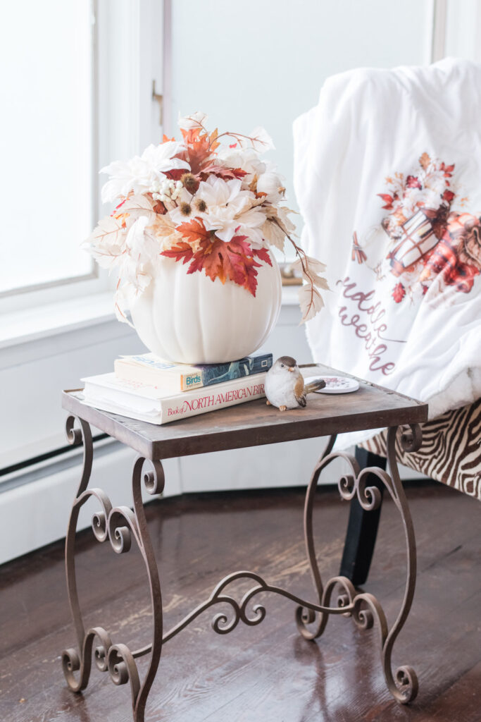 Thrifted, right iron and wood table decorated for fall