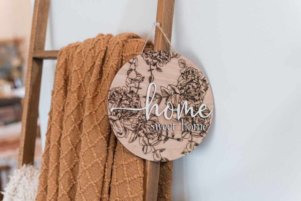  blanket ladder with fall blankets, and a home sign 