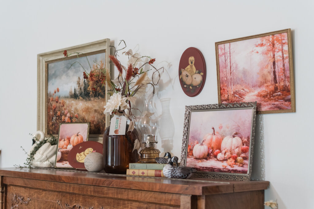 Fall display above an old piano with printable art and hand painted pieces and thrifted treasures 