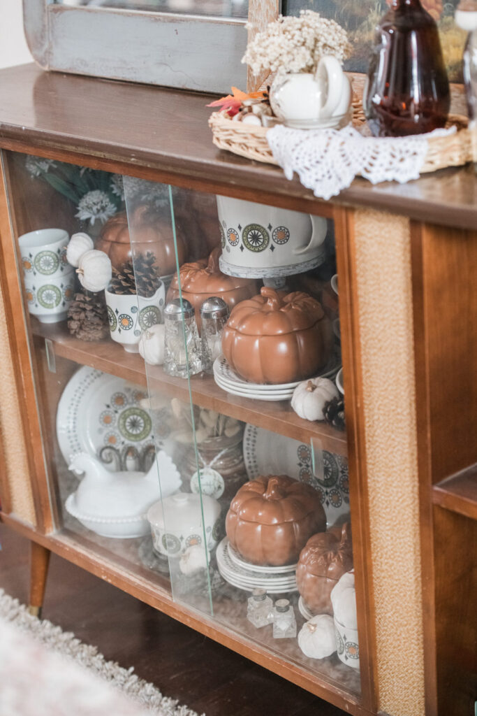 Vintage china cabinet with passed down, dinnerware decorated for fall