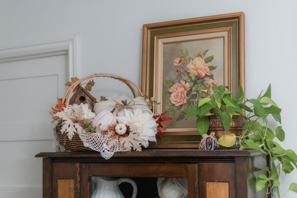 Harvest baskets with a vintage handpainted, art piece and greenery for fall 