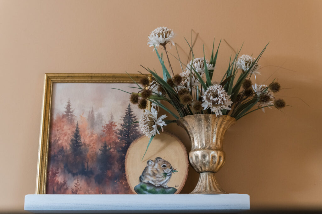  fall florals, and a printed landscape with a hand-painted pica on a shelf in the bathroom for fall