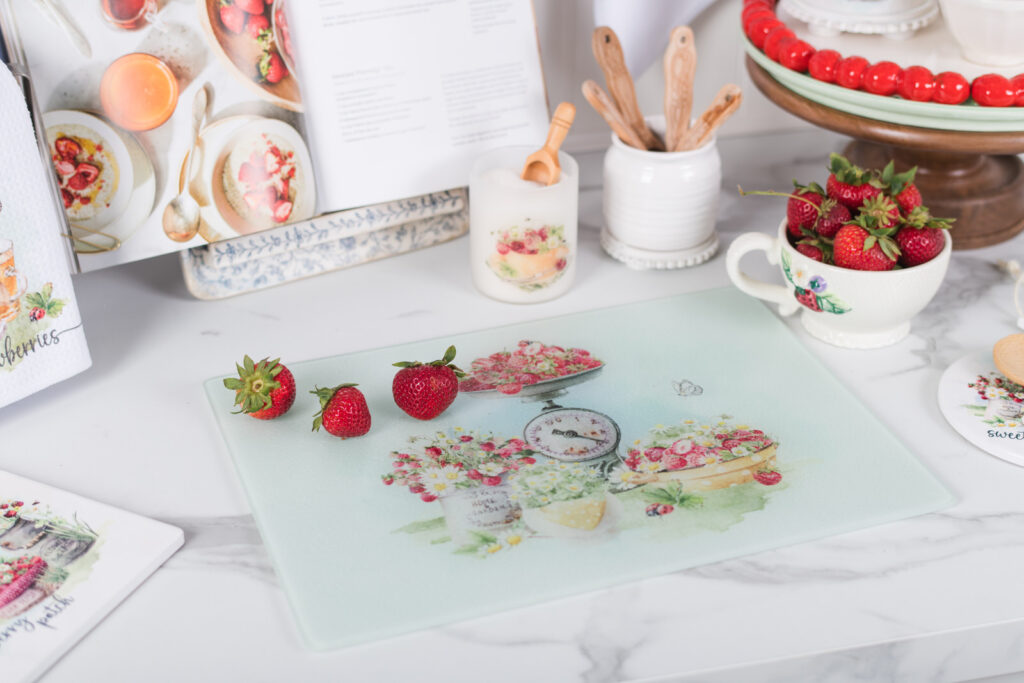 Glass strawberry cutting board styled in a cottage kitchen