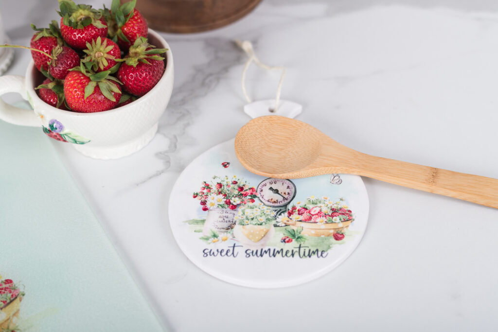  Watercolor strawberry trivet as a spoon rest on a farmhouse counter.