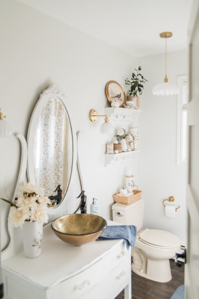 Cottage-style bathroom makeover with vintage vanity, fresh white paint, and fall accents from the Vintage Autumn Collection.