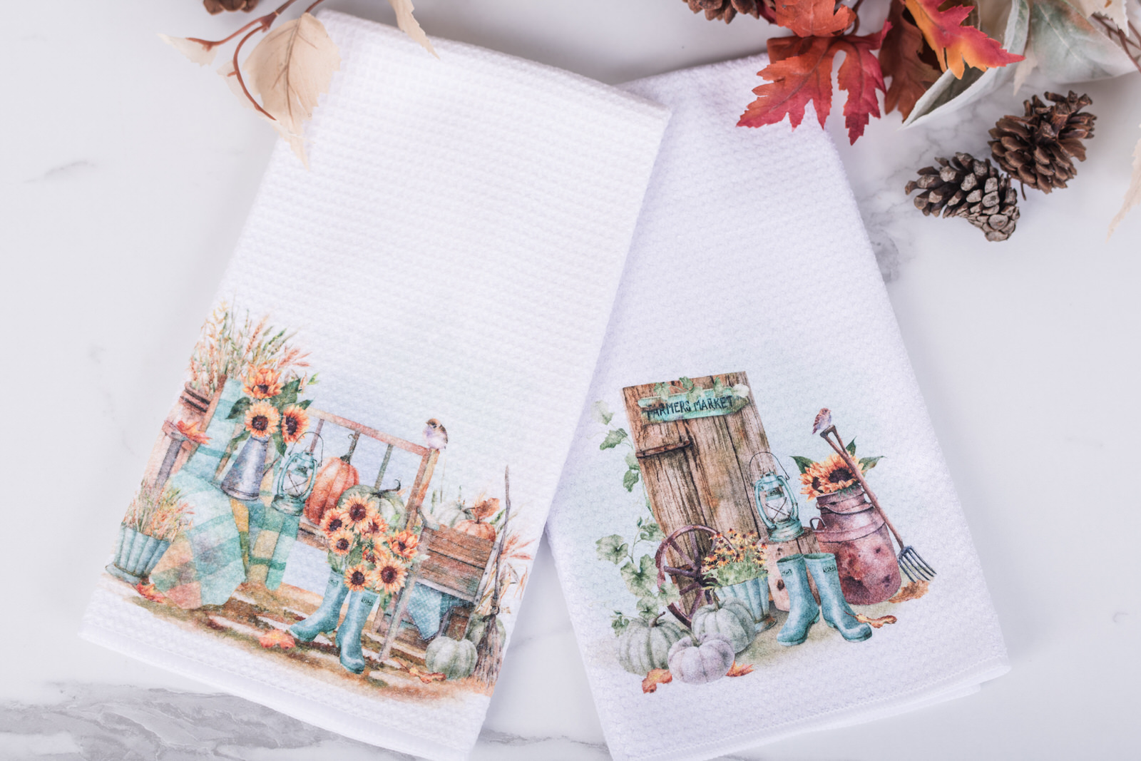 Pumpkin Patch Collection tea towels with watercolor pumpkins and autumn florals styled in a cozy farmhouse kitchen.