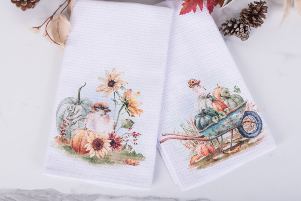 Fall harvest garden style kitchen towels with watercolor pumpkins, birds and florals in a cozy kitchen
