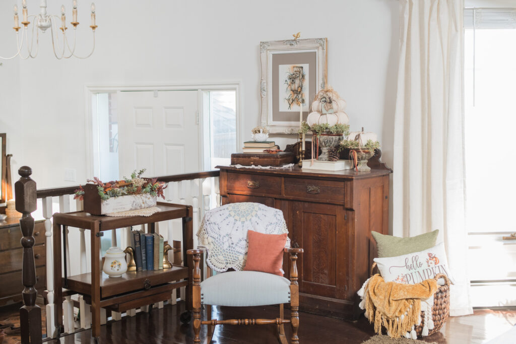 Cozy fall living room corner with vintage rocking chair and crocheted throw, tea cart and antique cabinet