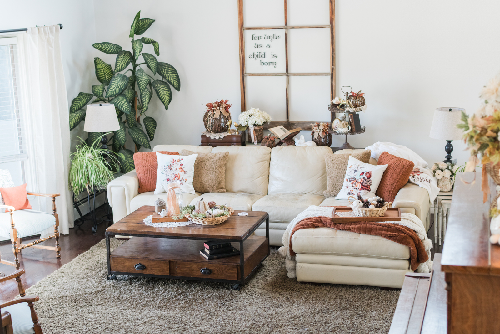 Cozy fall sectional with layered pillows and rust throw blanket