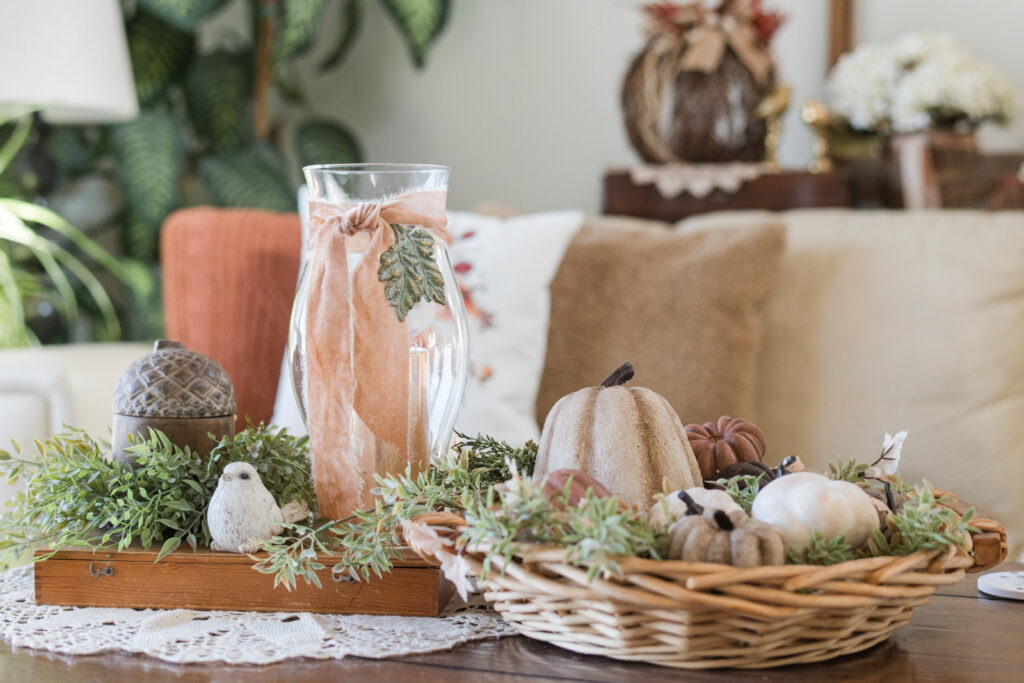 Cozy farmhouse coffee table decorated for fall with handmade pumpkins and candlelight