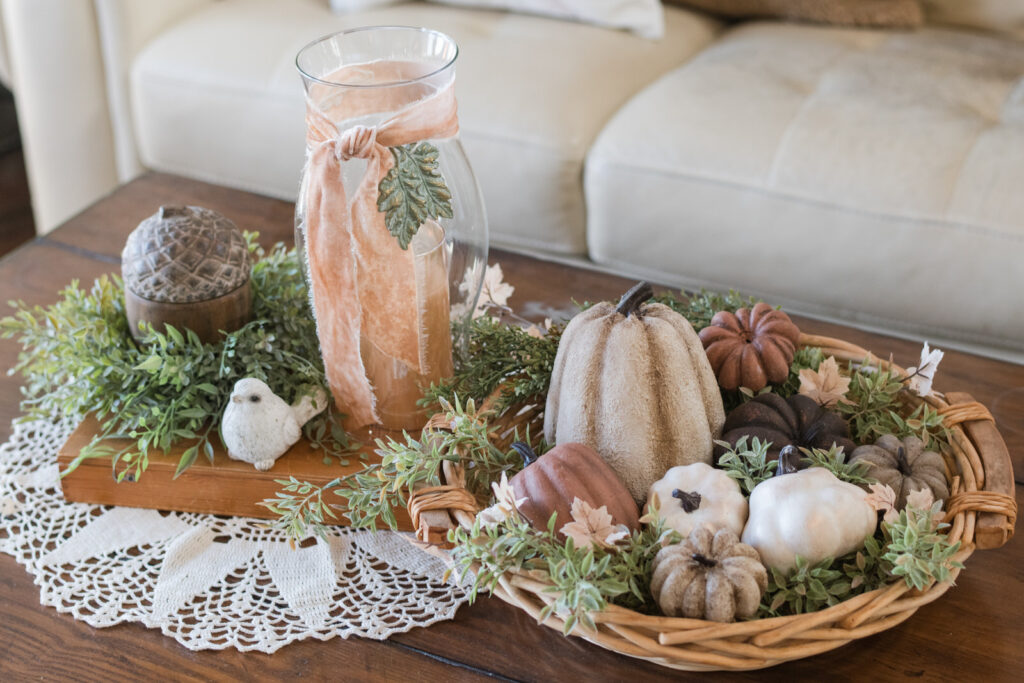 Fall coffee table styled with a woven basket of DIY painted pumpkins and gourds