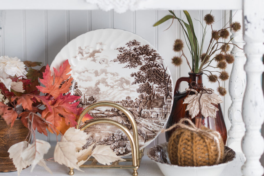 Fall decor with brown, transferware plates, and fall foliage