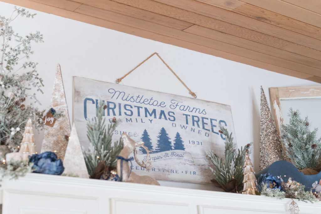 Handmade Christmas tree farm sign above kitchen cabinets with vaulted ceiling