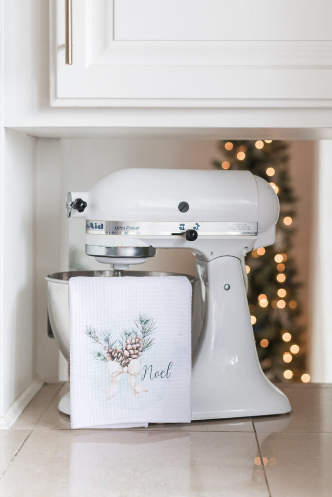 noel tea towel hanging on a Kitchen-Aid mixing bowl on kitchen counter
