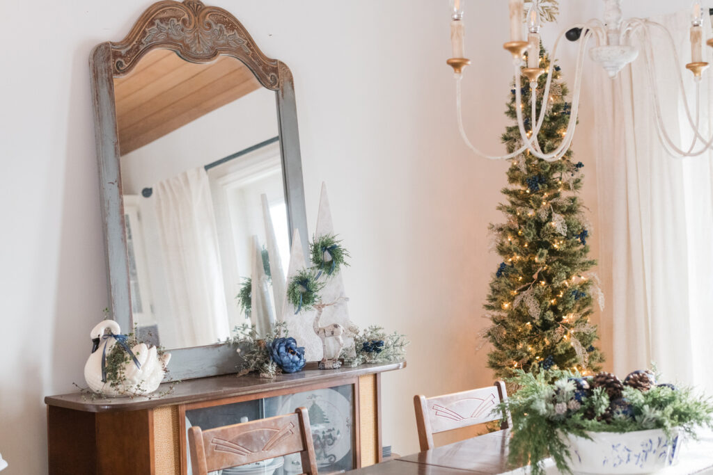 Simple farmhouse Christmas table setting with white runner and navy ornaments