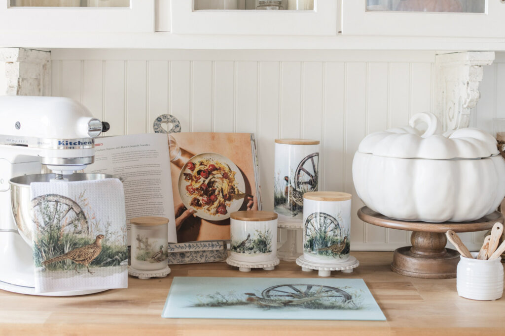 Fall tea towel draped over KitchenAid mixer bowl in cozy baking nook with coordinating kitchen decor
