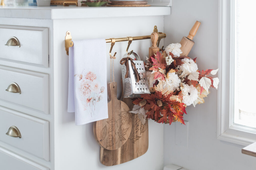 Towel bar on the end of the kitchen cupboard decorated for fall