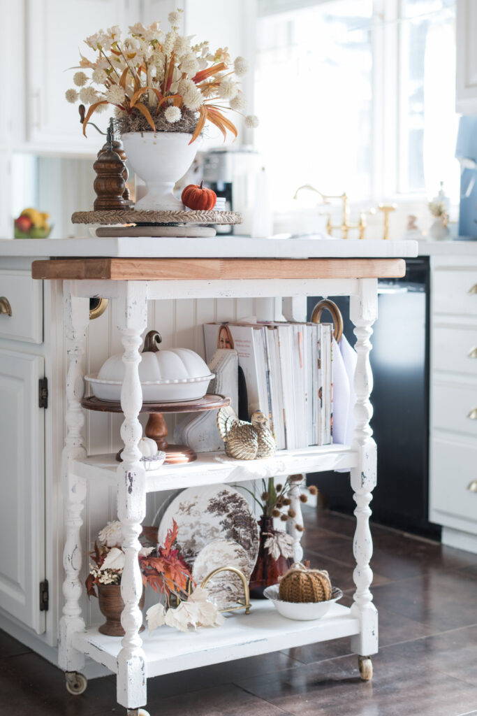 Cottage-style kitchen cart makeover using milk paint, styled for fall with vintage accents and butcher block top.
