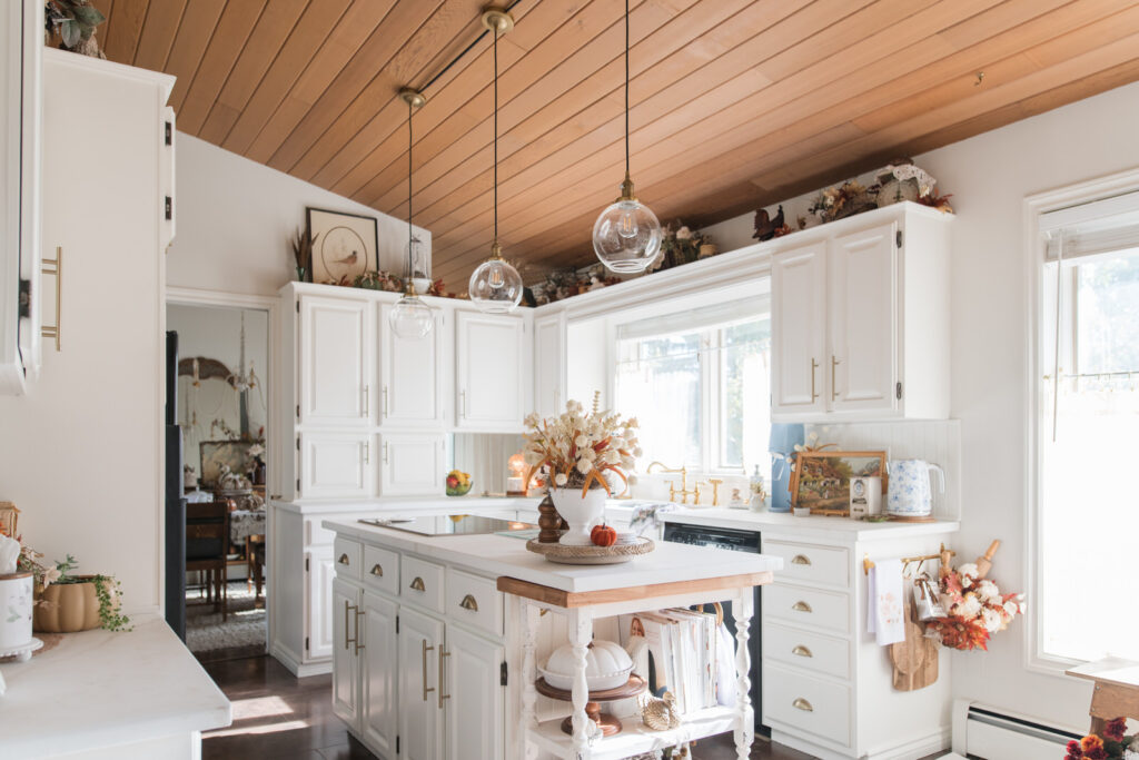 White vintage-style kitchen decorated with fall collections and seasonal tea towels