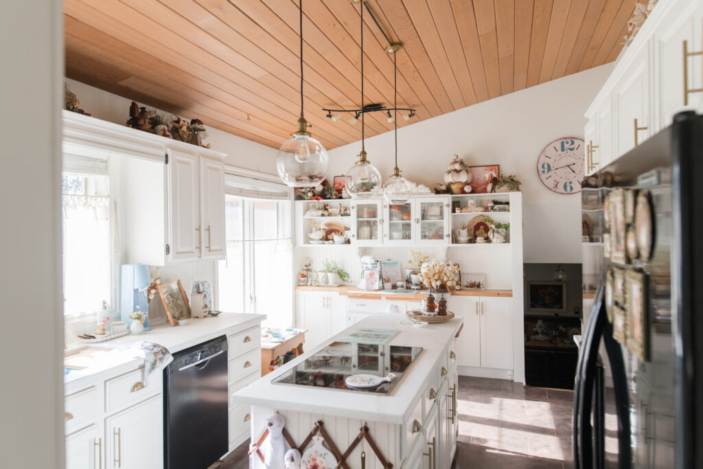 Fall 2025 kitchen decor with white cabinets, brass faucet, and cozy cottage styling.