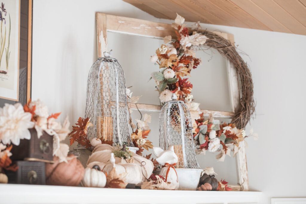 wired cloches and weather window with fall wreath layered with pumpkins and florals