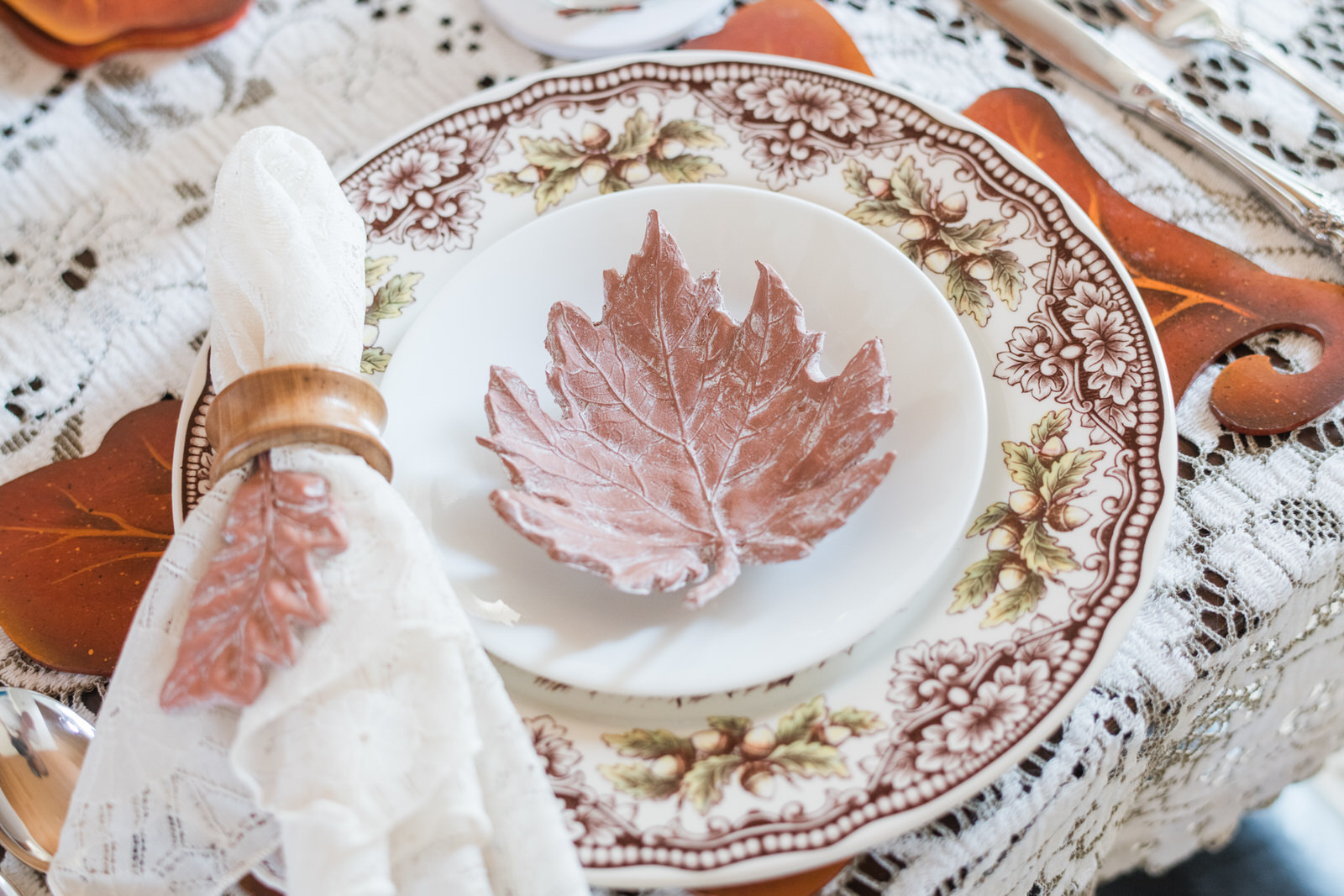 DIY clay leaf bowl for Thanksgiving styling on a dining room table