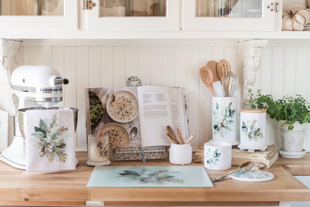 Fall tea towel draped over KitchenAid mixer bowl in cozy baking nook with coordinating fall decor