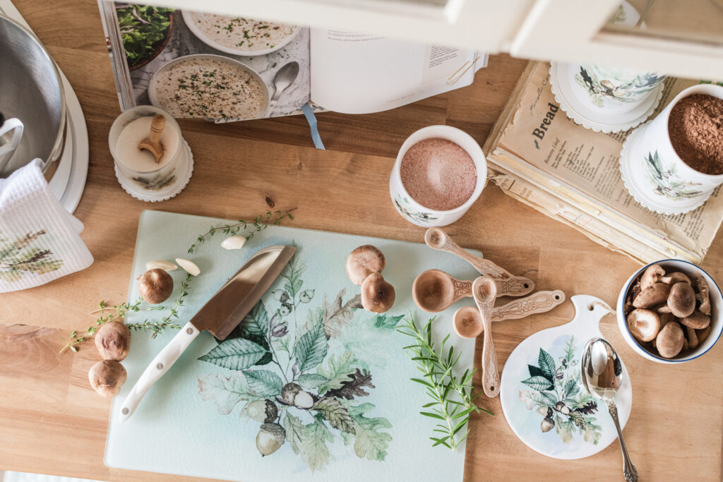 Woodland Collection glass cutting board beside a mixer, used as a prep surface or a trivet for bread fresh from the oven in a cozy fall baking corner.