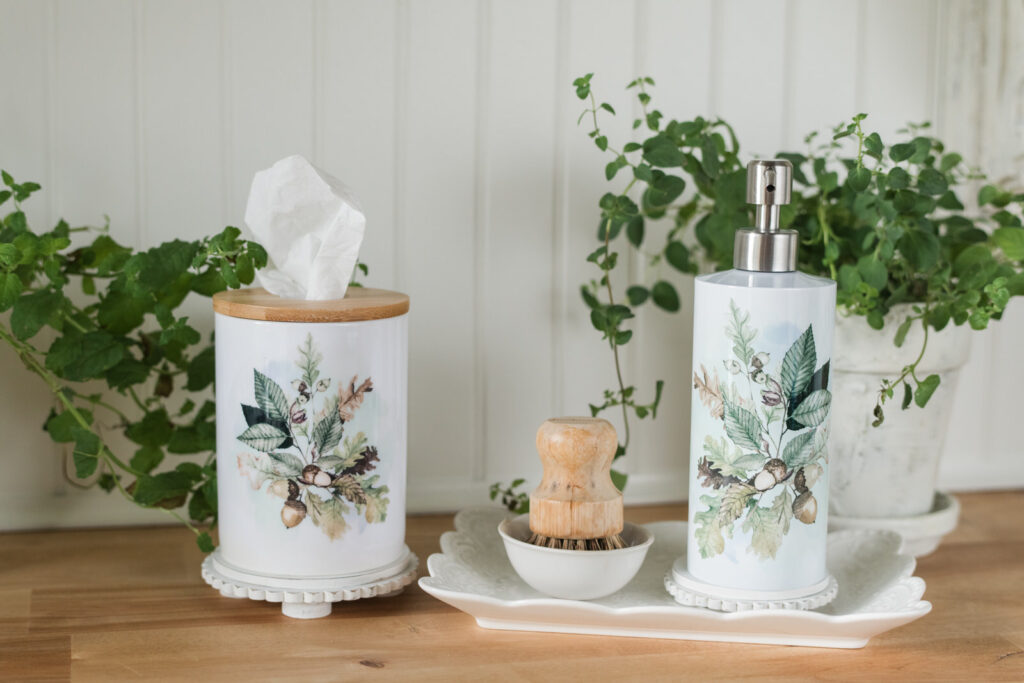 Soap holder on a plate with a kitchen pot scrubber beside a ceramic tissue holder 