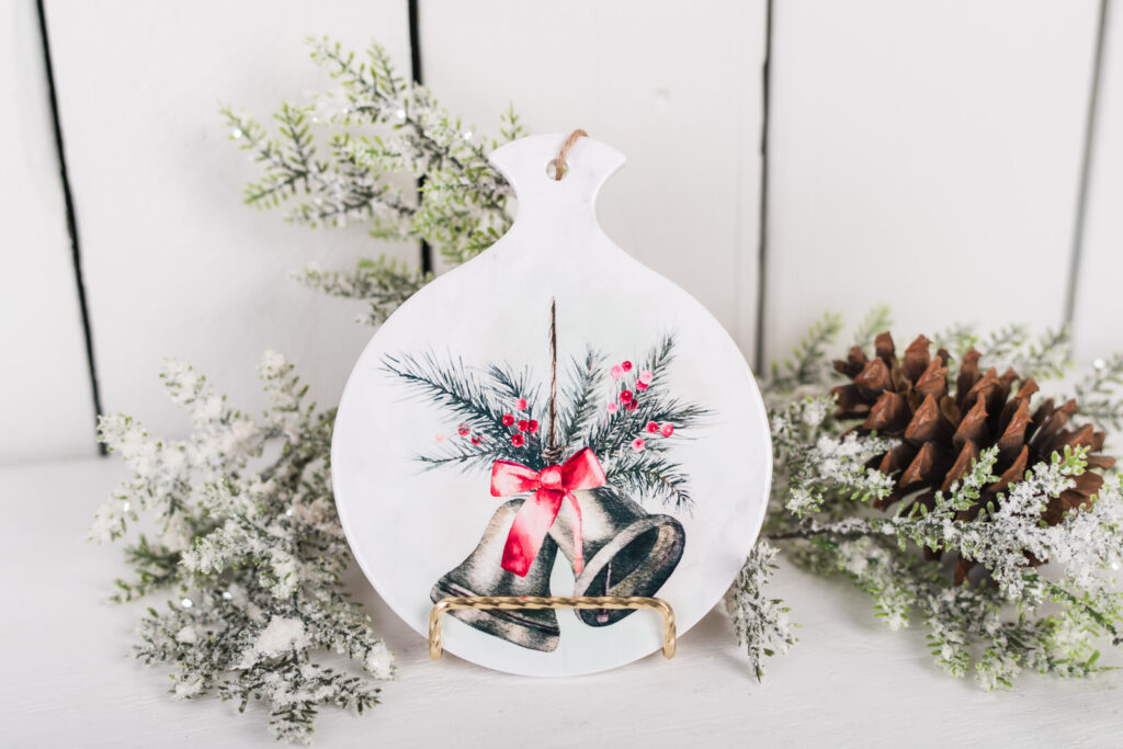 ceramic trivet or spoon rest with red ribbon and Christmas bells