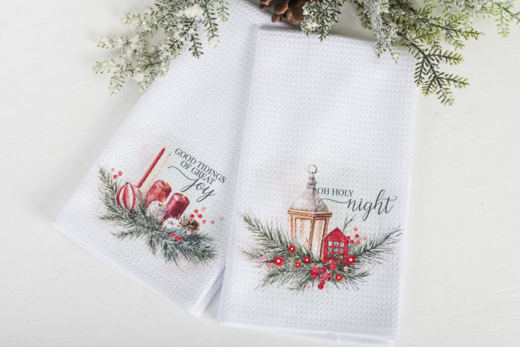 Classic Christmas tea towel with red poinsettias, cardinal, and scripture design