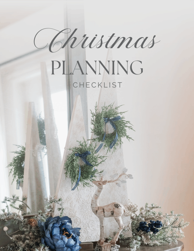 6-Week Countdown to Christmas Checklist free printable planner styled with DIY Textured trees, blue florals, greenery and a reindeer against a mirror