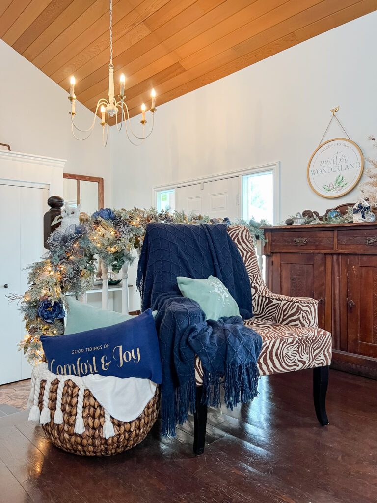 Christmas living room decor with turquoise and navy pillows in a woman basket with throws and a navy throw and turquoise handmade pillow in a zebra print chair