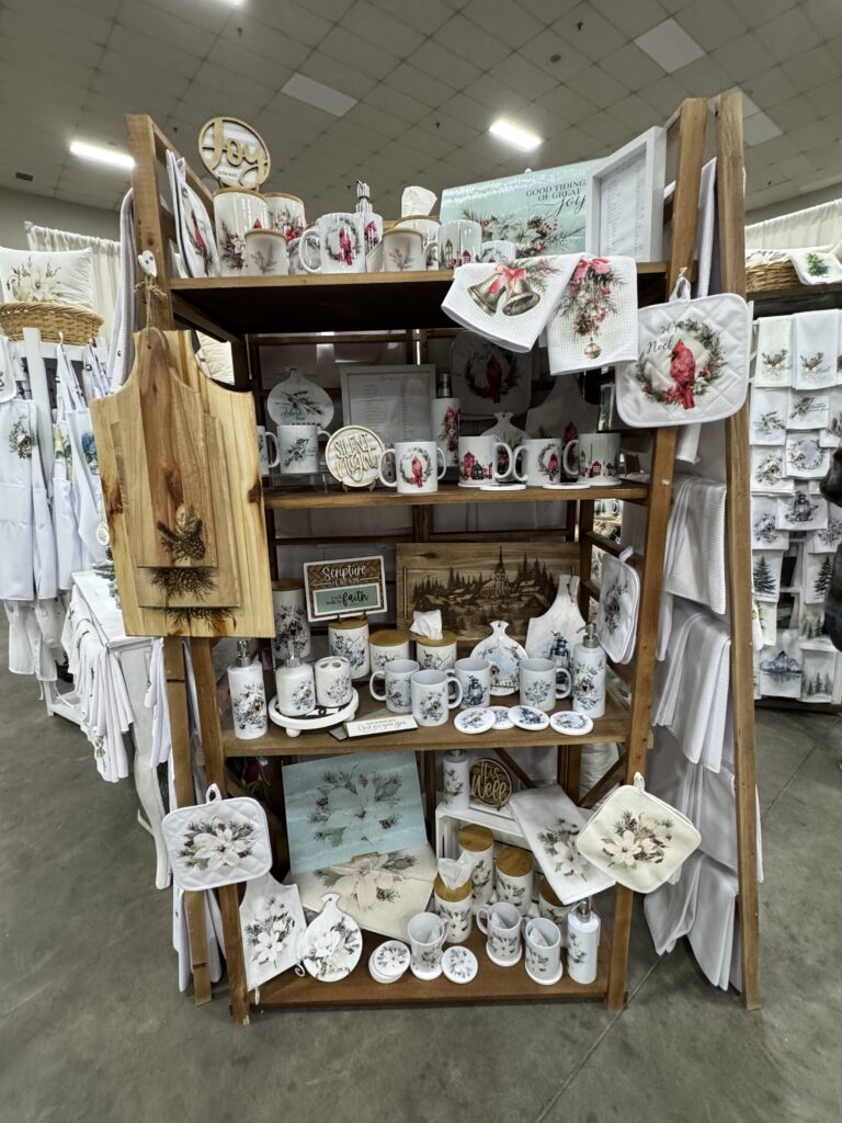 t Home With Chic & Grace ready-to-gift bundles and Christmas tea towels displayed at the Living Stones Church Ladies Night Market in Red Deer.