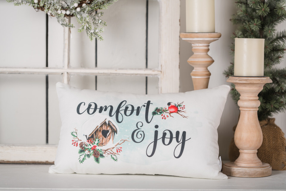 Comfort and enjoy pillow with a red bird, weathered birdhouse with red berries and Christmas greenery