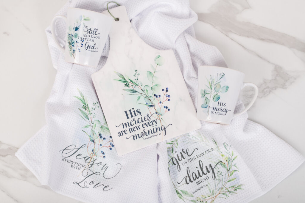 Winterberry kitchen gift set with scripture. A rectangle trivet, two tea towels, and two latte mugs or tea cups.