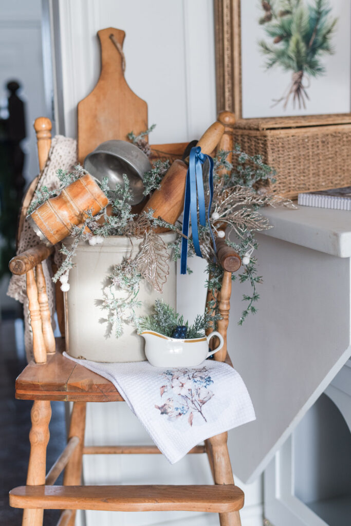 Tea towels used as Christmas kitchen decor draped over racks, bowls, and furniture