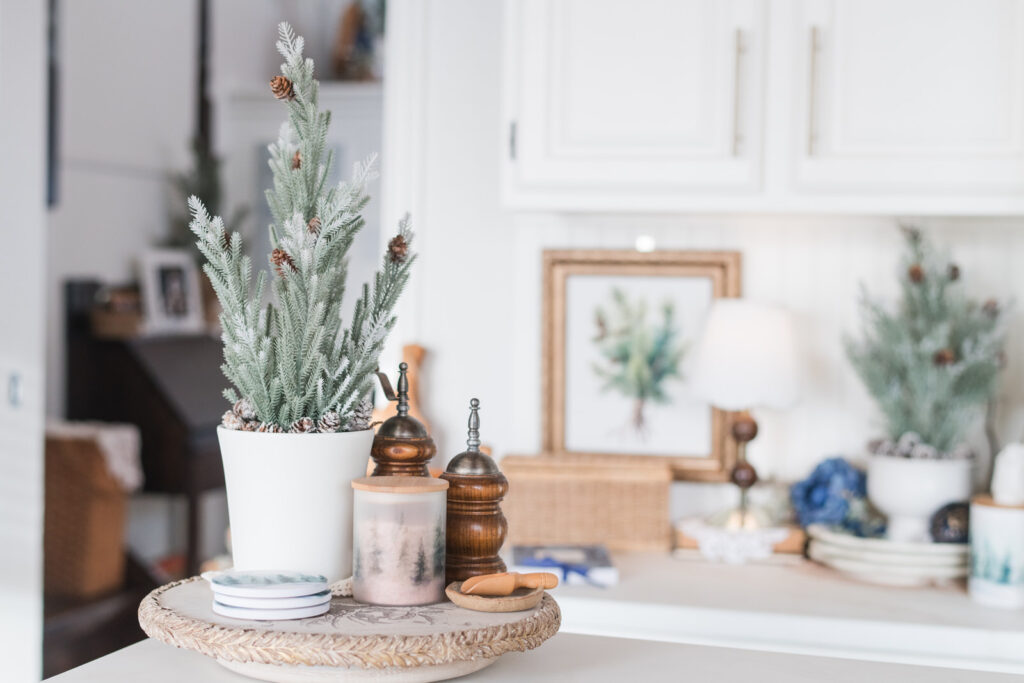 Kitchen island with Lazy Susan styled with coasters and a cannister from the forest collection and a Christmas tree