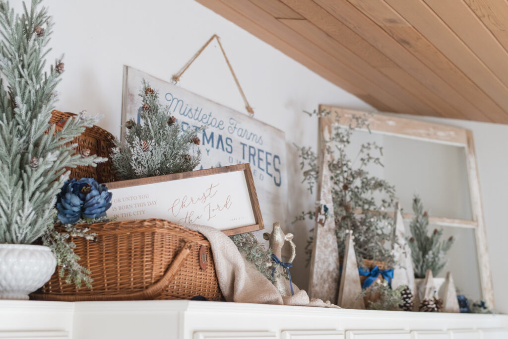 Above cabinet Christmas styling with faux trees, baskets, and collected holiday decor