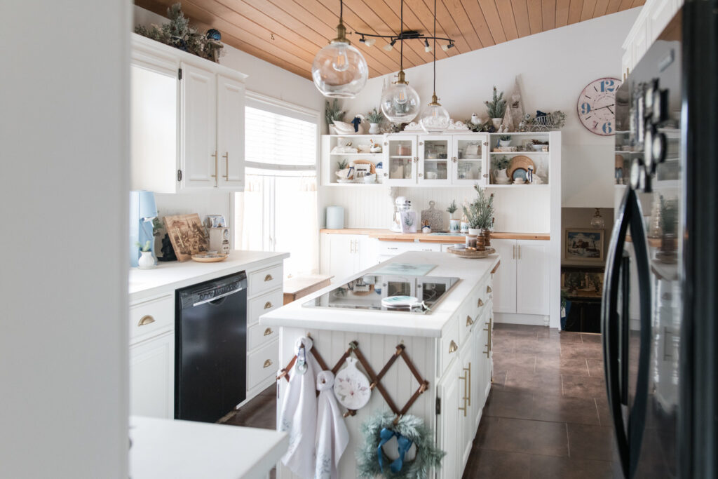 Christmas kitchen decor featuring white cabinets, blue accents, and classic cottage-style holiday touches