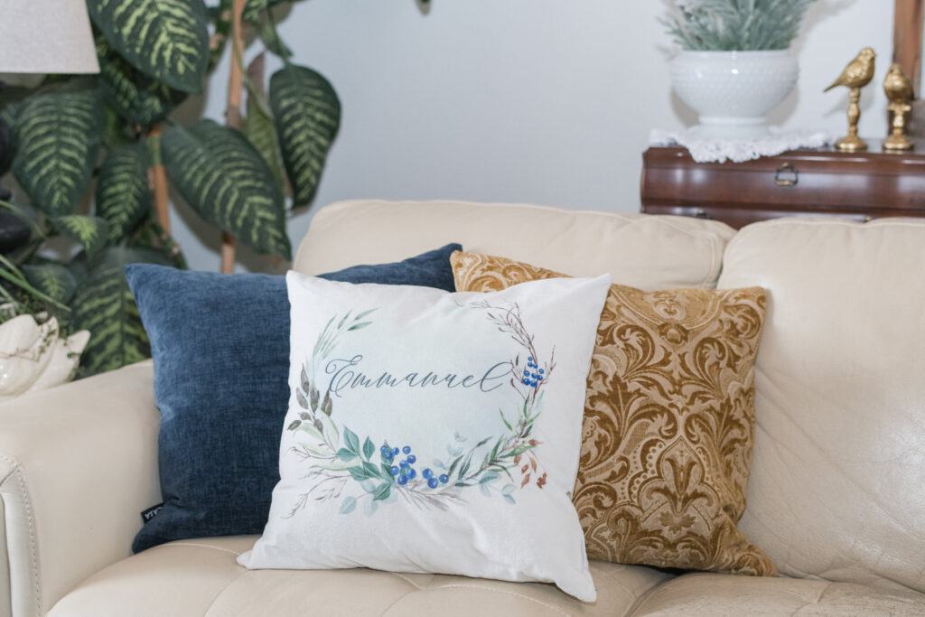 blue, gold and white layered pillows for Christmas on a sofa 