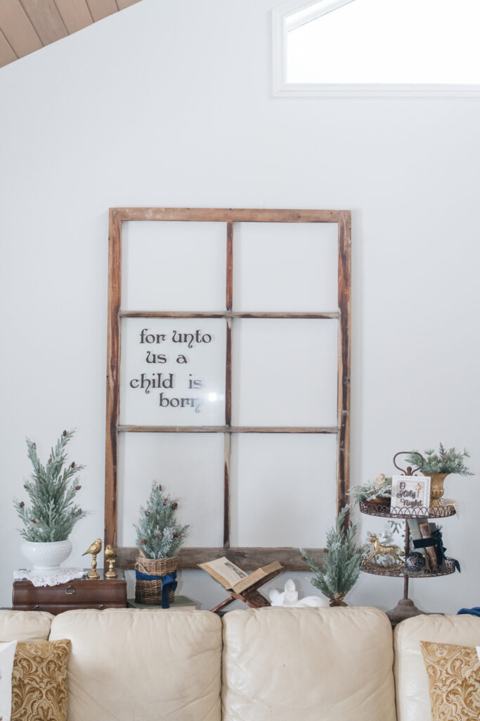 window frame in Christmas living room with unto us a child is born